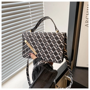 Detailed view of the diamond pattern and bear motif on this fashionable crossbody bag