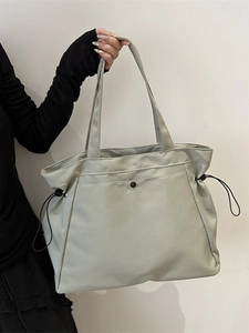 Light gray large capacity tote bag with side drawstrings and waterproof nylon texture