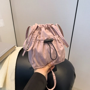 Pink drawstring bucket bag in minimalist nylon, versatile casual crossbody for daily wear