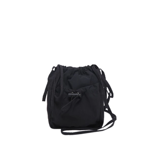 Minimalist black nylon drawstring bucket bag with adjustable front pocket and slim shoulder strap