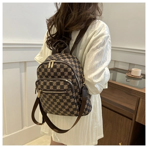 Detail of the checkered plaid women's backpack with multiple zipper pockets and straps