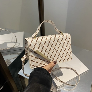 Chic cream crossbody bag with brown grid patterns and bear prints on a stylish mini flap