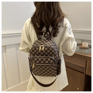Detail shot of the brown checkered mini backpack with golden metal zipper and PU texture