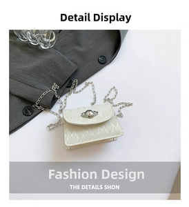 Detail of white mini bag with M-letter print and silver Saturn metal clasp