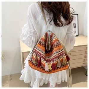 Ethnic boho tote bag detail showing geometric woven patterns and long fringe tassels