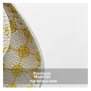 Detail of white lychee leather texture with yellow pattern and fine stitching on the bag