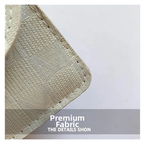 Macro shot of beige woven fabric with letter patterns and precise white stitching