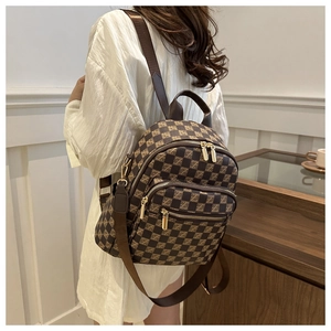 Detail view of large capacity plaid backpack with golden zippers and multi-layer pockets