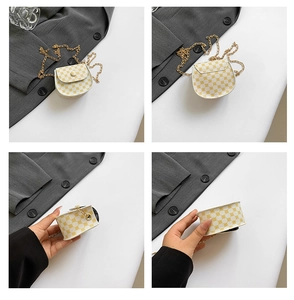 Detail view of mini yellow checkered chain bag with gold strap and cloth-covered button