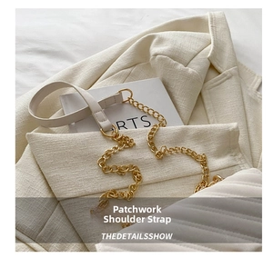 Close-up of cream white leather and gold metal chain strap with fine stitching