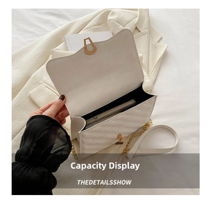 Detailed internal view of the white quilted crossbody bag showing smartphone storage