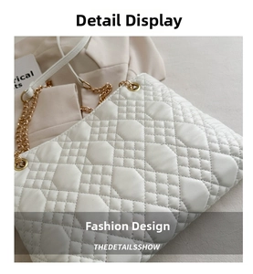 Close-up of white geometric quilted shoulder bag with elegant gold chain strap details
