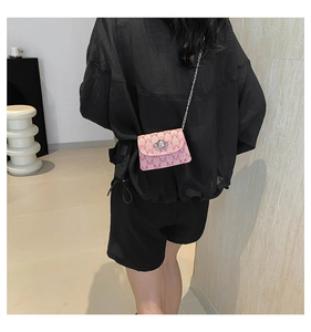 Detail of pink jacquard mini bag with Saturn logo hardware and metal chain strap