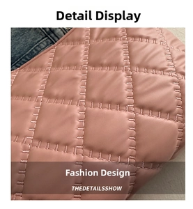 Close-up of pink quilted leather texture with precise stitching on a stylish tote bag