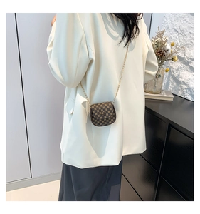 Mini vintage print crossbody bag with gold chain strap shown on white blazer outfit