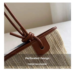 Detail of hand-woven straw tote with brown leather strap and decorative knot design