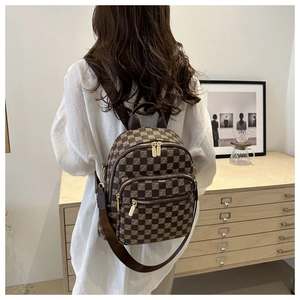 Lifestyle shot of a brown checkered women's backpack with adjustable straps in a home setting