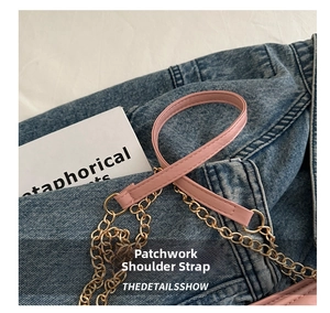 Detail of pink leather shoulder strap with gold chain links on a quilted tote bag
