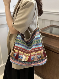 Ethnic bohemian tote bag with colorful geometric patterns and decorative fringe tassels
