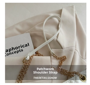 Detail of white quilted leather handbag featuring a gold chain and leather strap