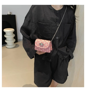 Detail of pink mini chain bag with letter print and silver Saturn metal clasp