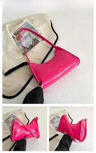 Close-up of rose red patent leather baguette bag with high gloss finish and half-moon curve