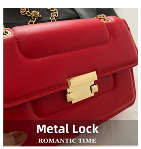 Detailed close-up of a red quilted chain bag with a gold square clasp and stud accents