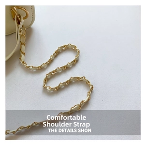 Detailed close-up of cream quilted bag featuring gold-tone chain and leather strap