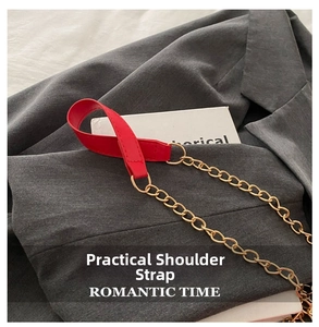 Close-up of red PU leather shoulder strap with gold metal chain for a minimalist bag
