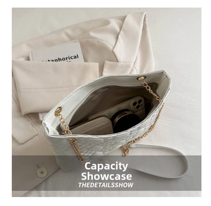 Spacious interior of white quilted tote bag with chain strap and luxury leather finish