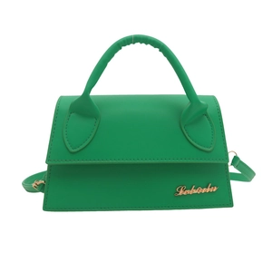 Fashionable bright green trapezoid handbag with gold metal logo and crossbody strap