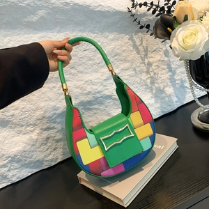 Green crescent shoulder bag with colorful geometric patchwork and gold metal buckle