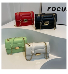 Chic chain crossbody bags in red, black, green, and white colors with gold metal buckles