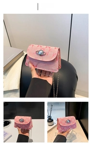 Detailed view of pink mini crossbody bag with M-pattern print and planet metal buckle