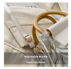Macro detail of retro jacquard bucket bag with adjustable gold buckle and white strap