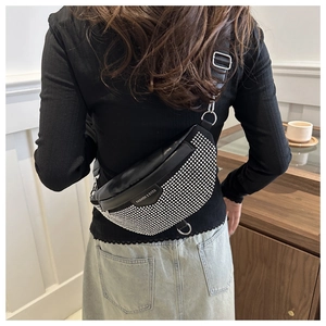 Detail of black crescent crossbody bag with silver rhinestones and fashion logo strap