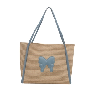 Minimalist woven straw tote bag with blue leather butterfly trim and top handles
