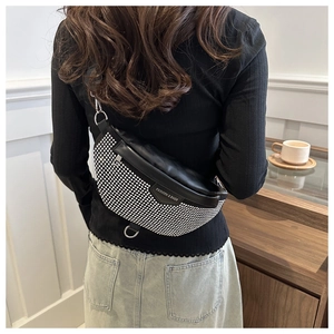 Close-up of black PU leather waist bag featuring silver rhinestones and metal buckles