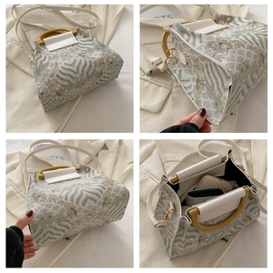 Detail view of the vintage embroidered bucket bag interior and wooden handle