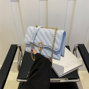 Light blue quilted shoulder bag with gold hardware and chain strap for women