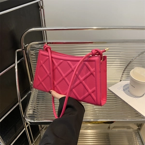 Magenta quilted shoulder bag with knotted straps and elegant rhombus pattern texture