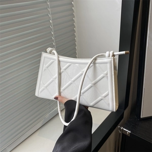 Minimalist white rectangular shoulder bag with geometric embossed texture and rope strap