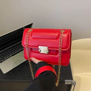 Red crossbody chain bag with premium leather texture and golden metal square lock closure