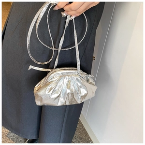 Detail of silver metallic pleated dumpling bag with fine texture and slim strap