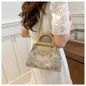 Close-up of vintage blue wave pattern jacquard fabric and stylish round wooden handle