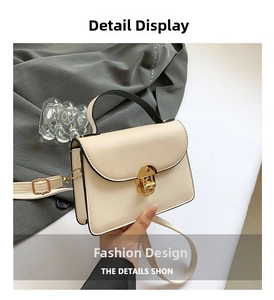 Detail of minimalist beige PU leather handbag with golden twist lock and black handle
