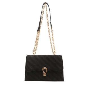 Elegant black quilted chain bag with a gold horseshoe buckle and metal shoulder strap