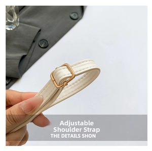 Detail of adjustable off-white leather strap with gold buckle for crossbody handbags