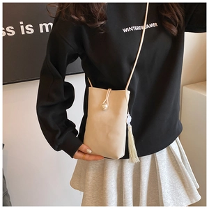 Elegant beige vertical mobile phone bag with pearl buckle and white tassel accessory