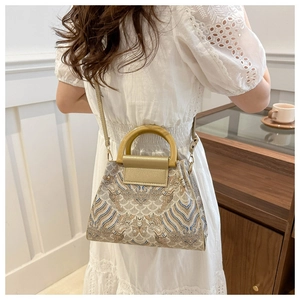 Retro embroidered bucket bag with vintage patterns and elegant wooden U-shaped handles